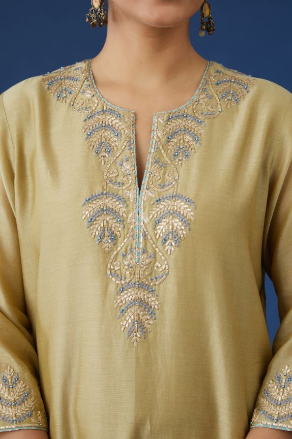 Olive silk chanderi straight kurta set with contrast silk thread and gota embroidery at neck and hem, highlighted with bead work.