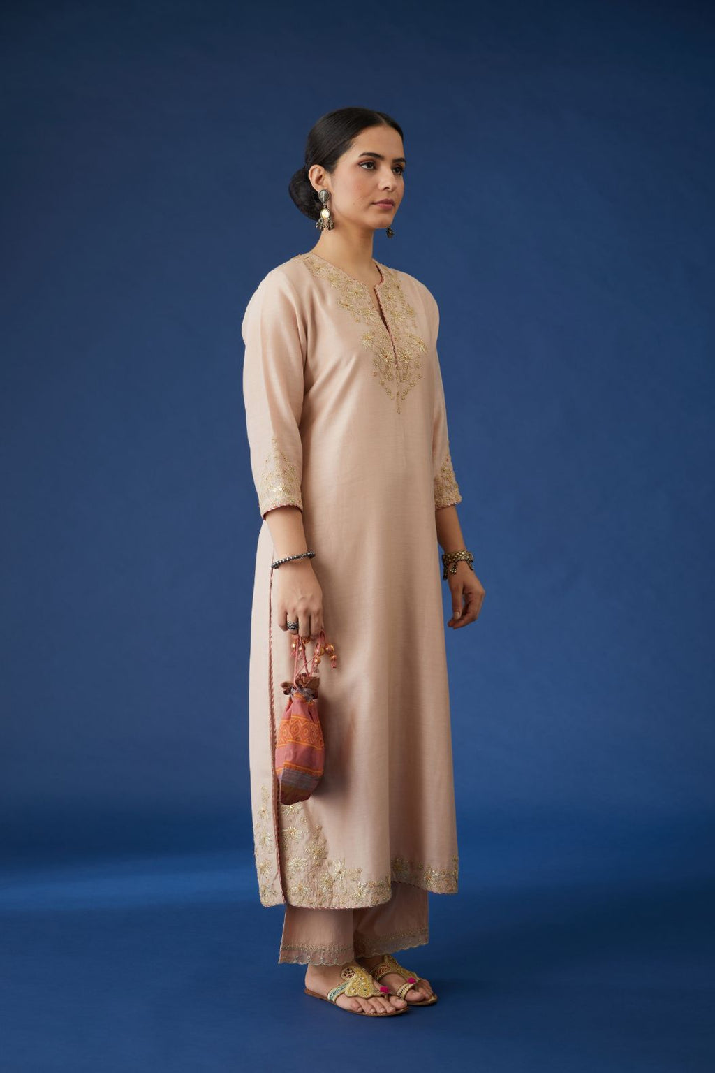 Dusty pink silk chanderi straight kurta set with gota embroidery at neck and hem, highlighted with bead work.