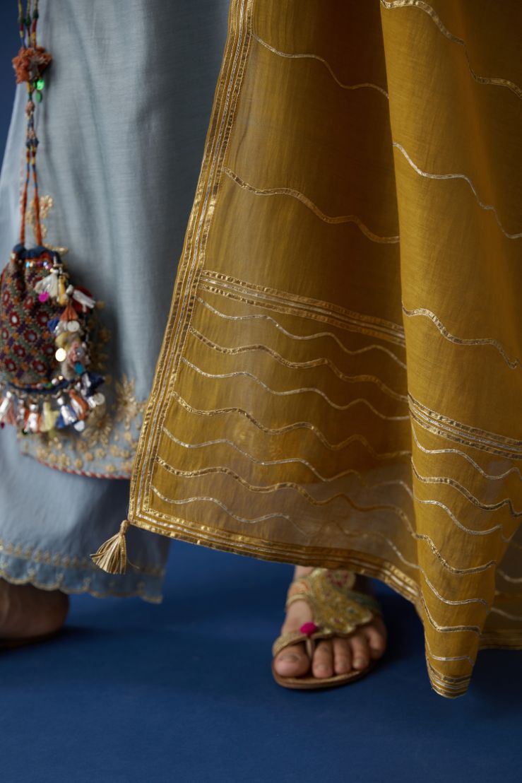 Bluish grey silk chanderi straight kurta set with gota embroidery at neck and hem, highlighted with bead work.
