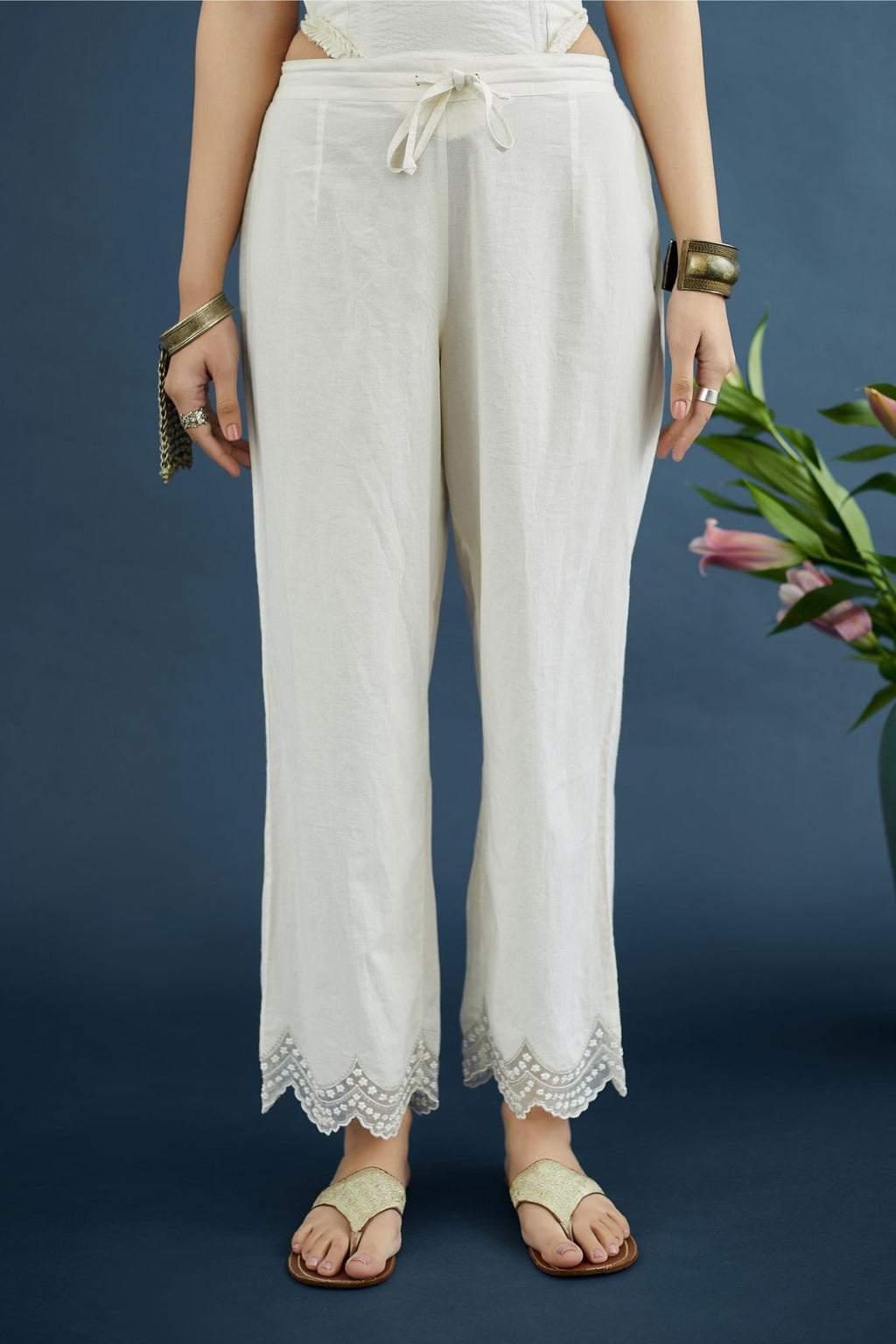Off white straight pants with scalloped embroidery at bottom hem