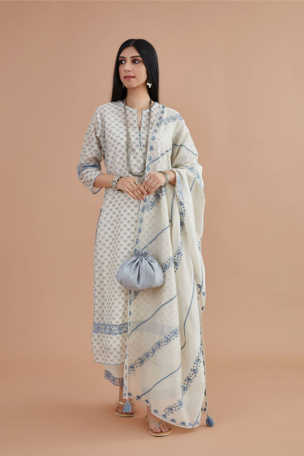 Off white silk chander kurta set with blue lotus hand block print, highlighted with blue thread embroidery inset and rickrack lace