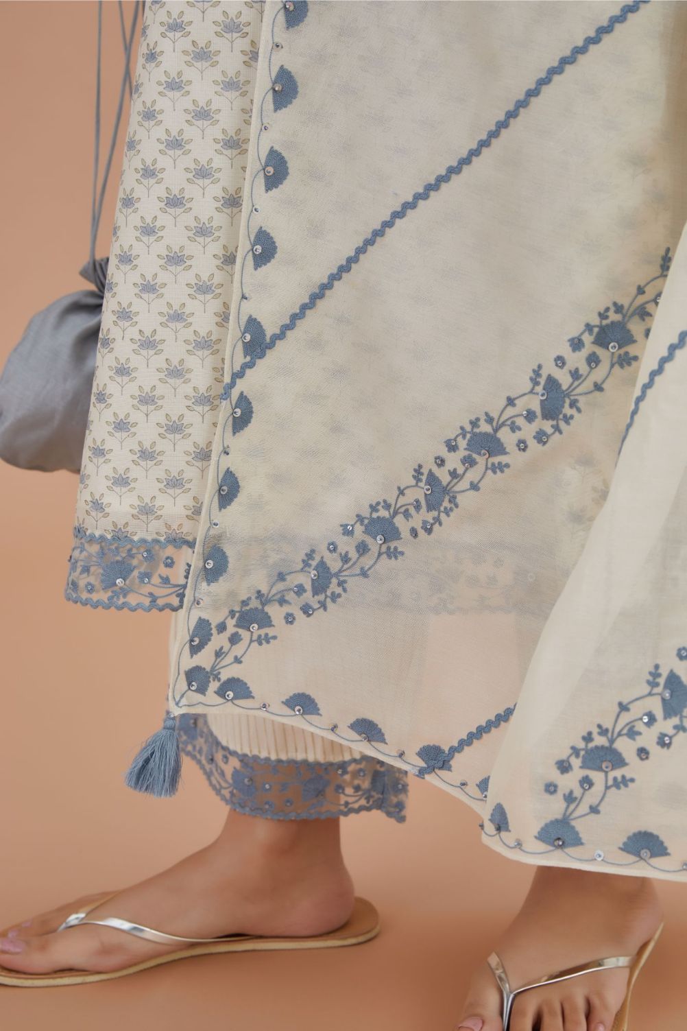 Off white silk Chanderi dupatta with all-over blue embroidery and rickrack, highlighted with sequin work.