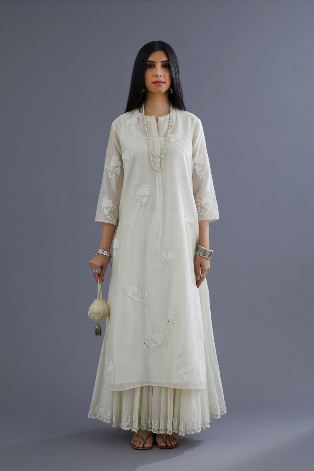 Off white silk chanderi kurta set with applique flower embroidery and lace detailing at neck and side slits