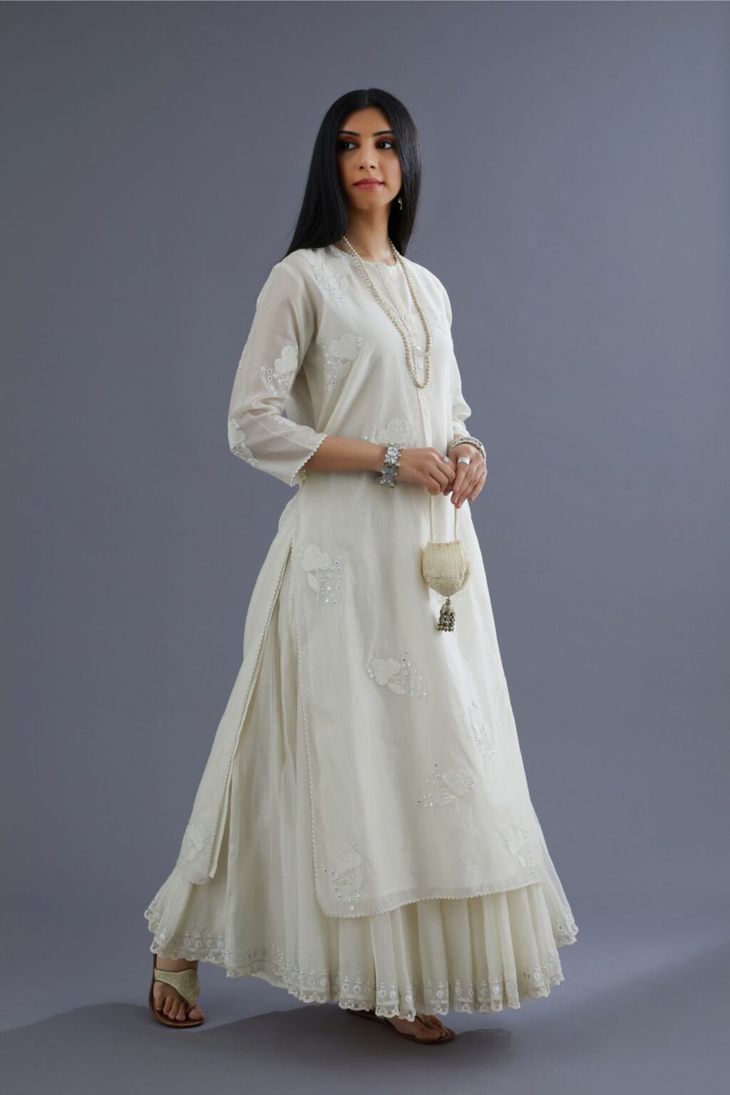 Off white silk chanderi kurta set with applique flower embroidery and lace detailing at neck and side slits