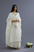 Off white silk chanderi kurta set with applique flower embroidery and lace detailing at neck and side slits