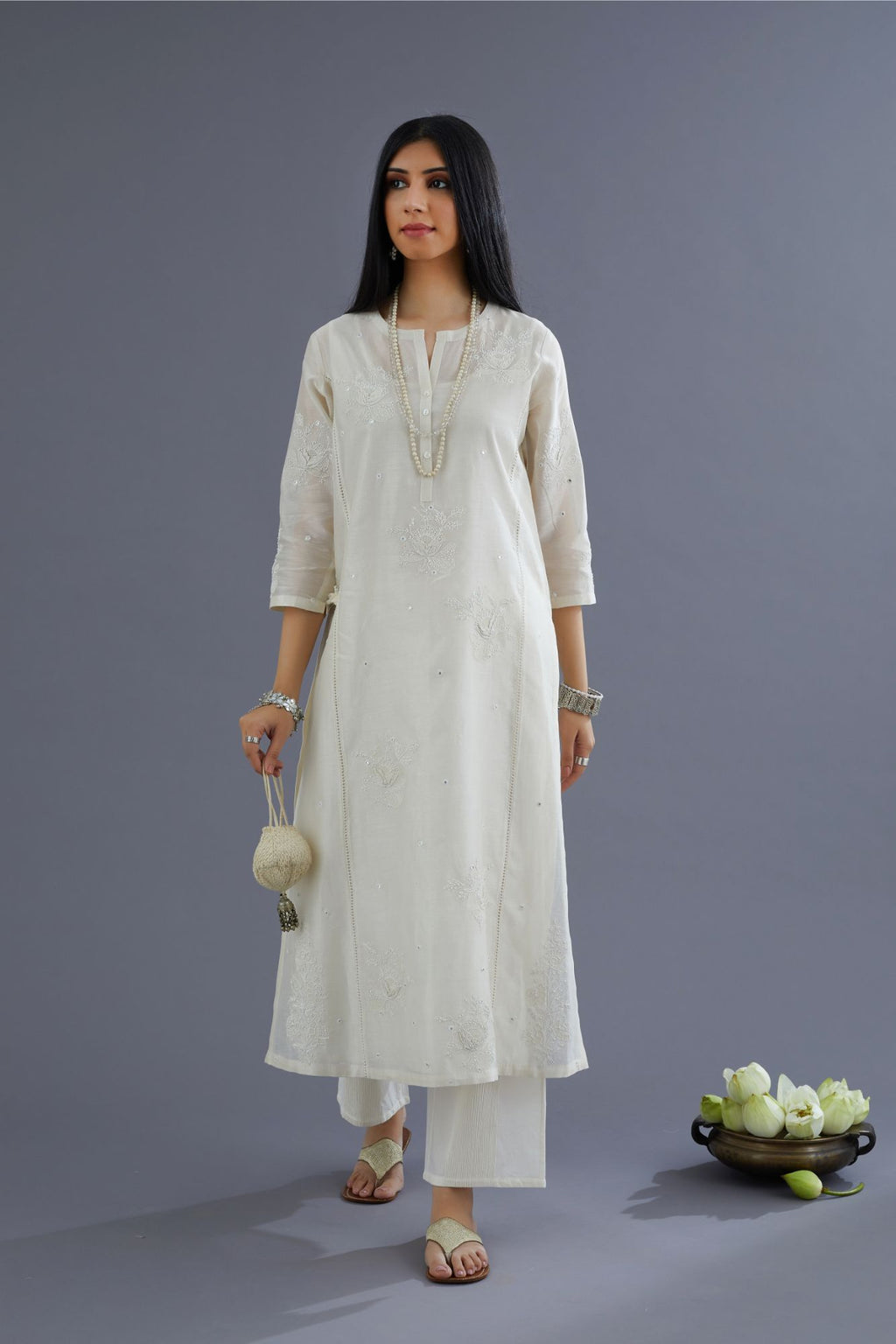 Off white silk chanderi kurta set with raised flower embroidery, highlighted with mirror hand work and beads