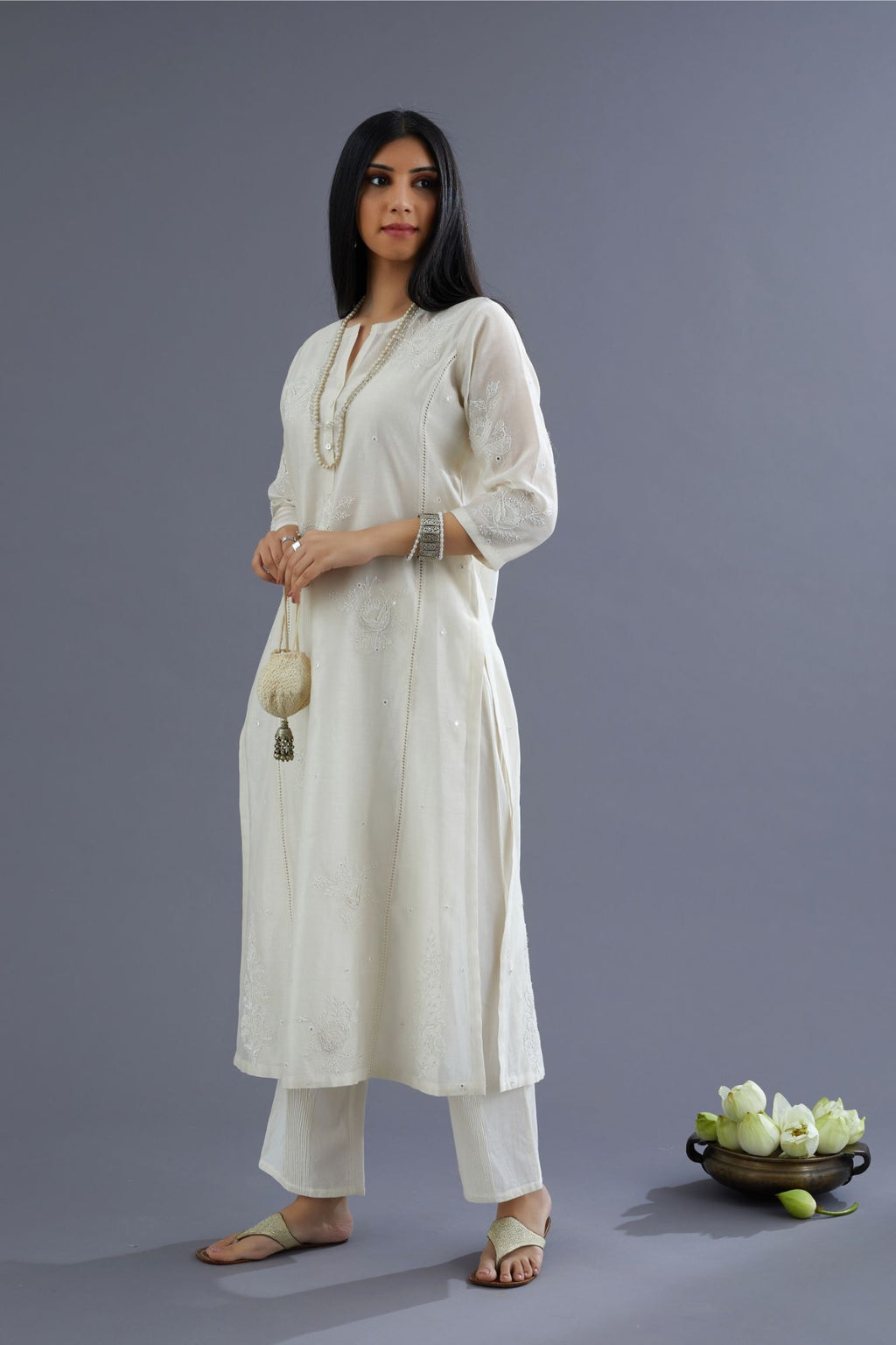 Off white silk chanderi kurta set with raised flower embroidery, highlighted with mirror hand work and beads