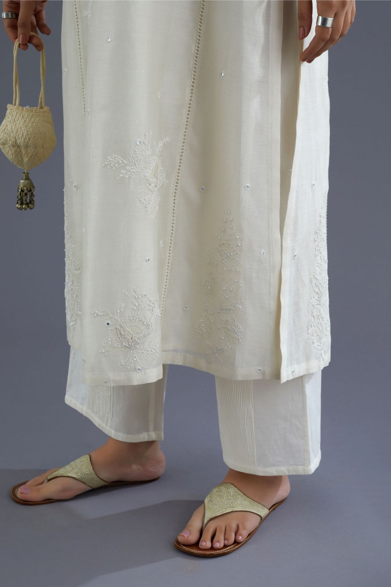 Off white silk chanderi kurta set with raised flower embroidery, highlighted with mirror hand work and beads