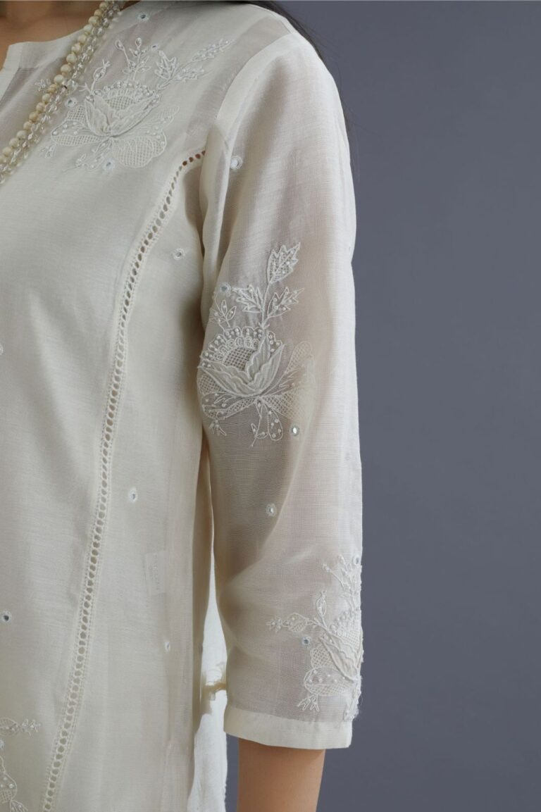 Off white silk chanderi kurta set with raised flower embroidery, highlighted with mirror hand work and beads