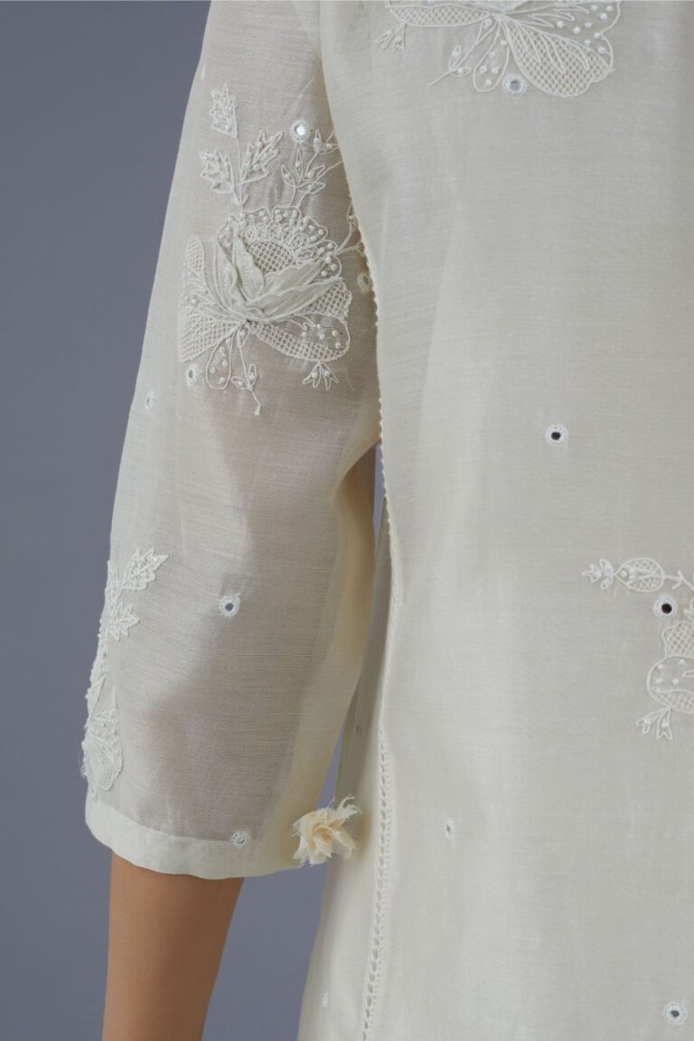 Off white silk chanderi kurta set with raised flower embroidery, highlighted with mirror hand work and beads