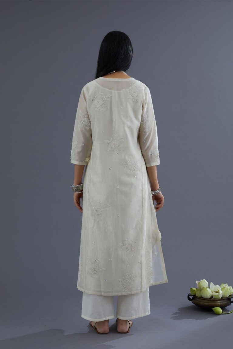 Off white silk chanderi kurta set with raised flower embroidery, highlighted with mirror hand work and beads