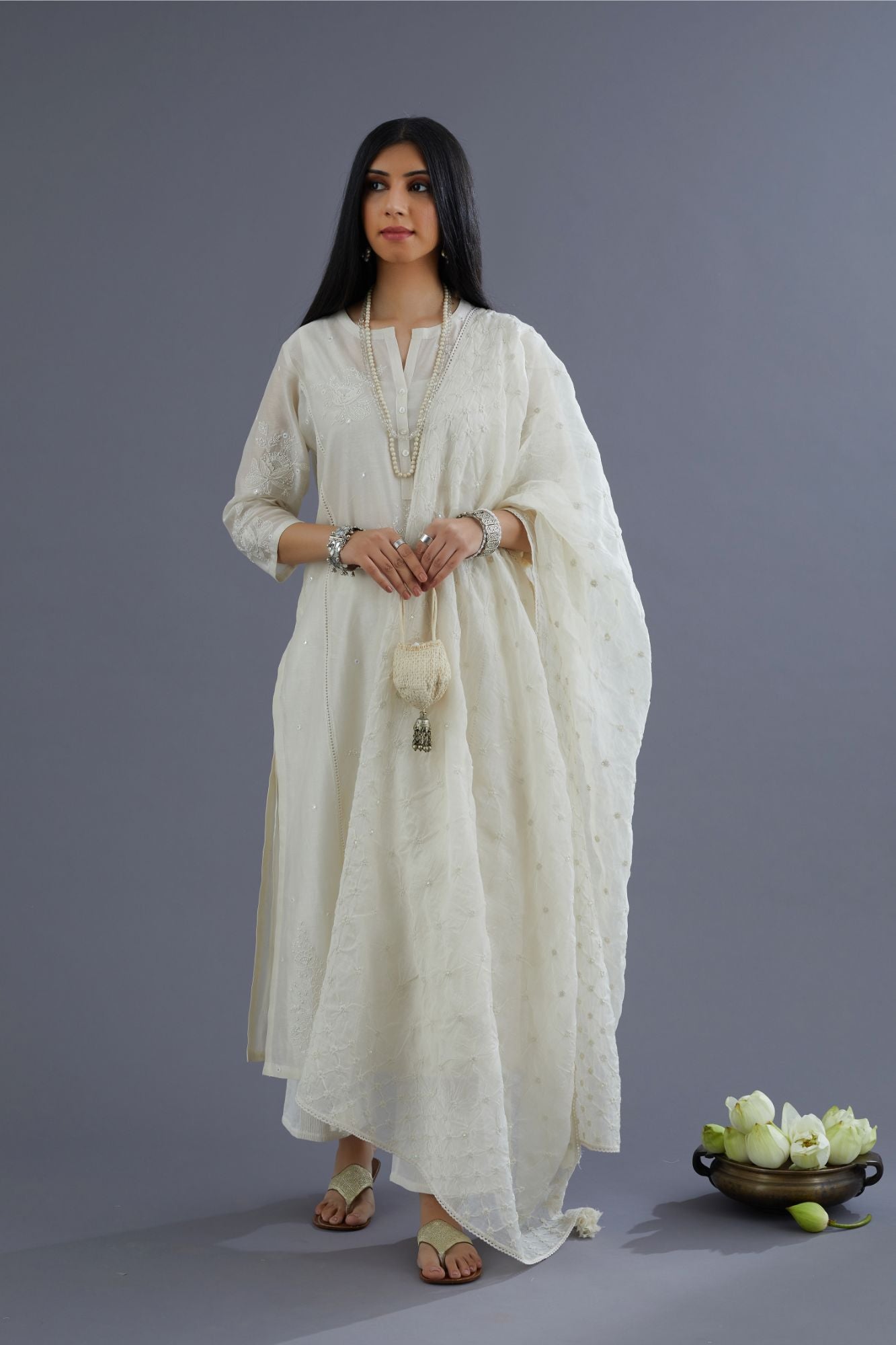 Off white silk chanderi kurta set with raised flower embroidery, highlighted with mirror hand work and beads