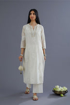 Off white silk chanderi kurta set with raised flower embroidery and mirror hand work