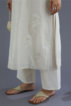 Off white silk chanderi kurta set with raised flower embroidery and mirror hand work