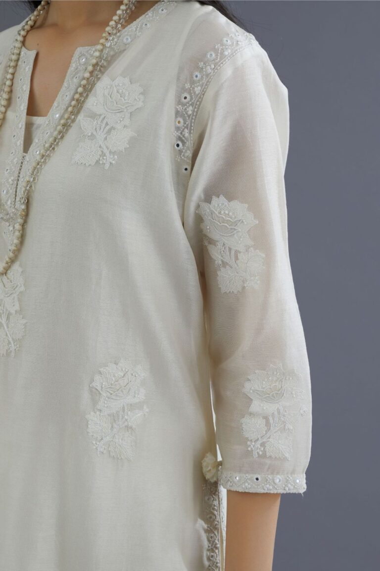 Off white silk chanderi kurta set with raised flower embroidery and mirror hand work