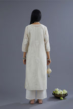 Off white silk chanderi kurta set with raised flower embroidery and mirror hand work