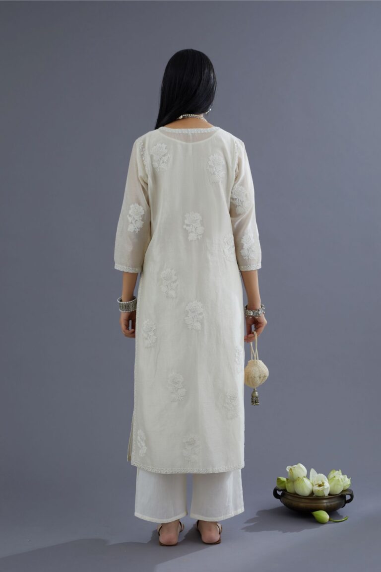 Off white silk chanderi kurta set with raised flower embroidery and mirror hand work