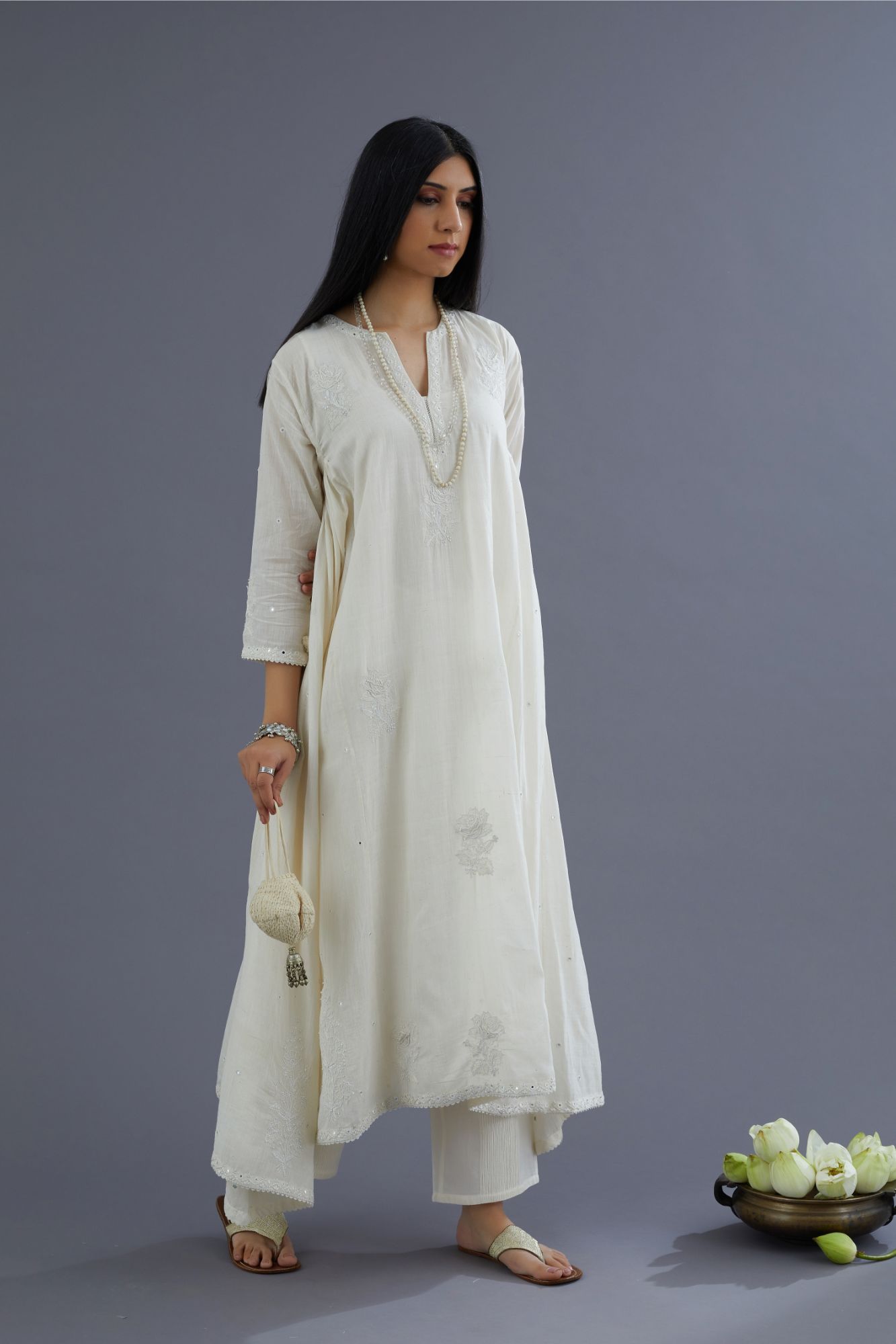 Off white Handspun Hand-Woven cotton kurta set with asymmetric hem, mirror hand work and raised flower embroidery
