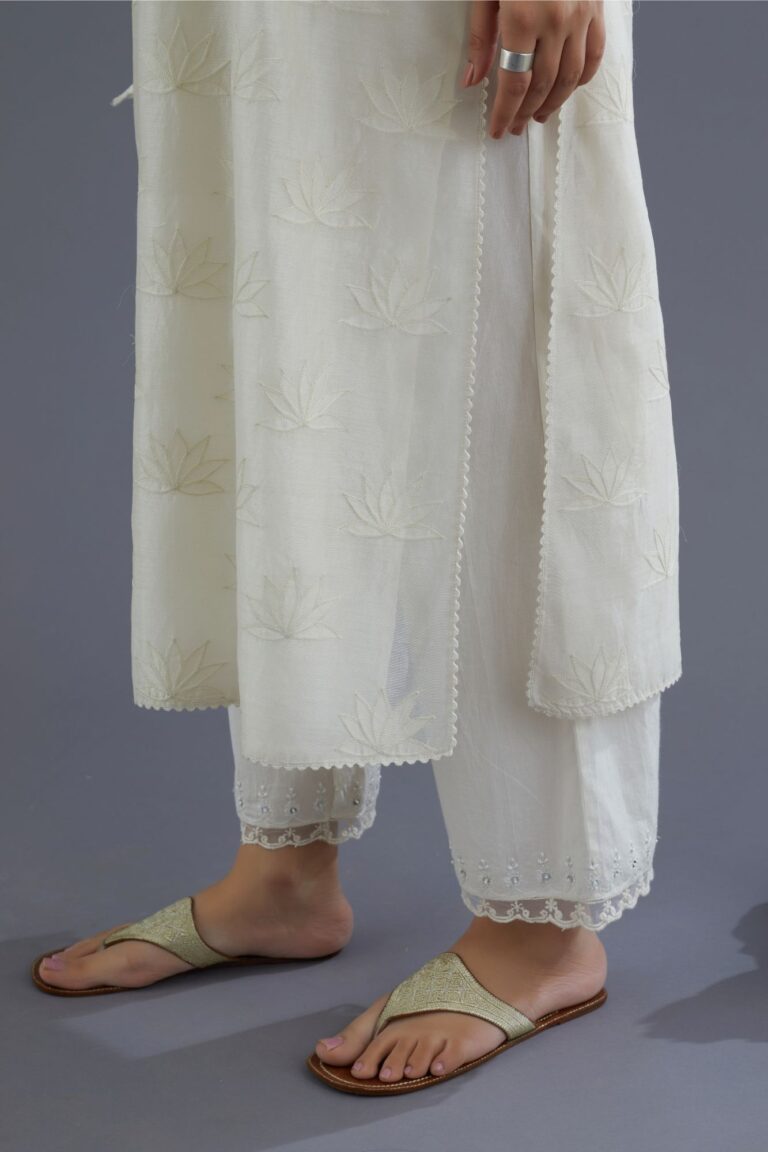Off white chanderi kurta set with all-over applique flower embroidery and lace detailing at neck and side slits