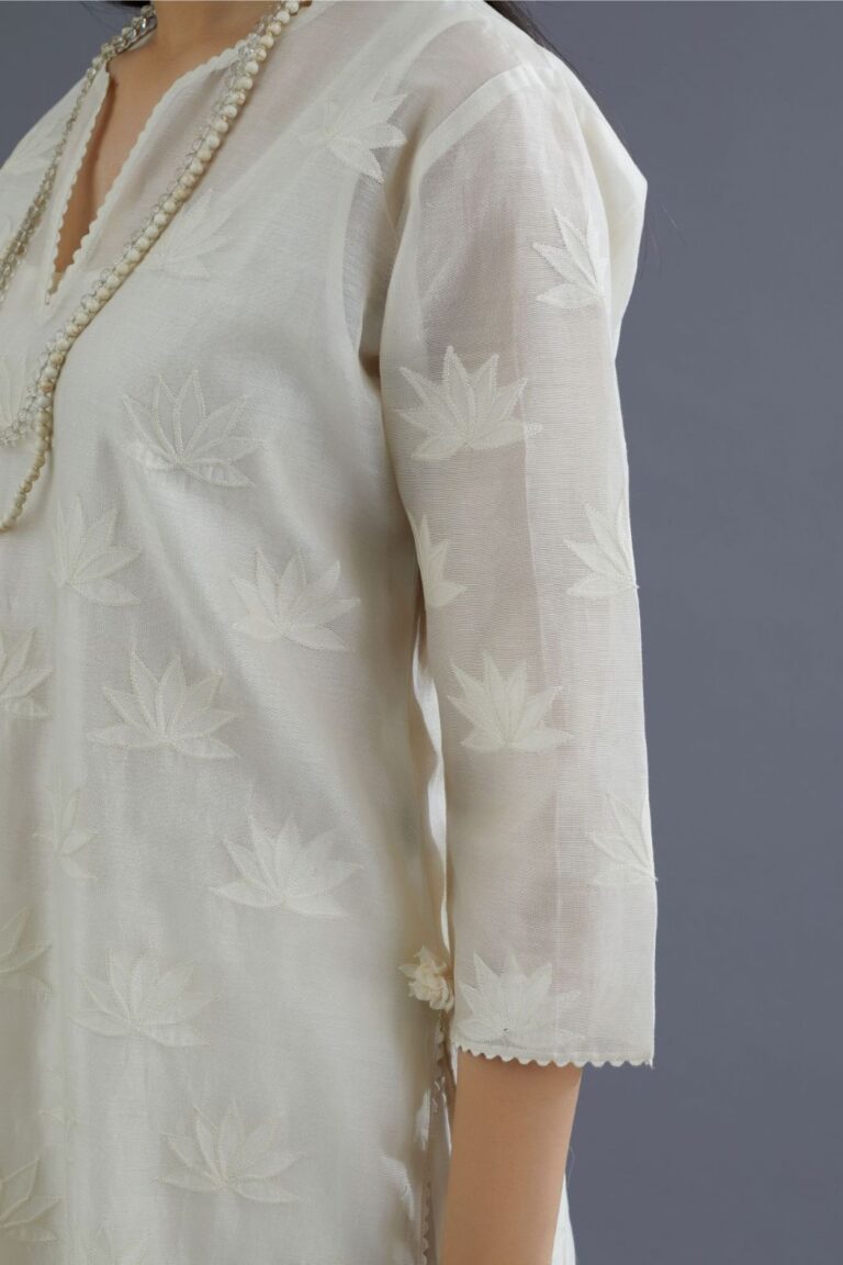 Off white chanderi kurta set with all-over applique flower embroidery and lace detailing at neck and side slits
