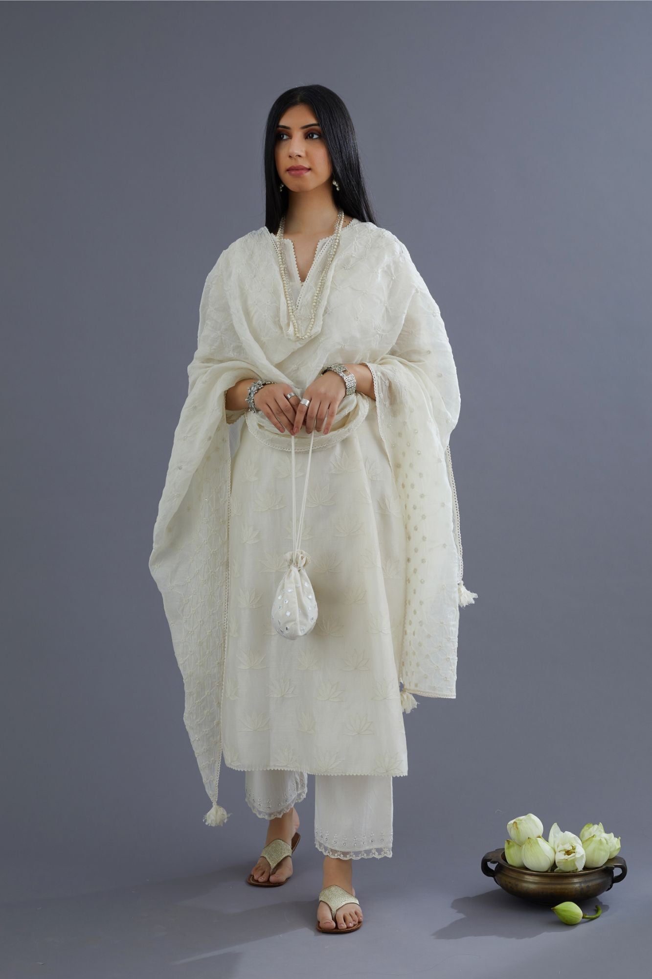 Off white chanderi kurta set with all-over applique flower embroidery and lace detailing at neck and side slits