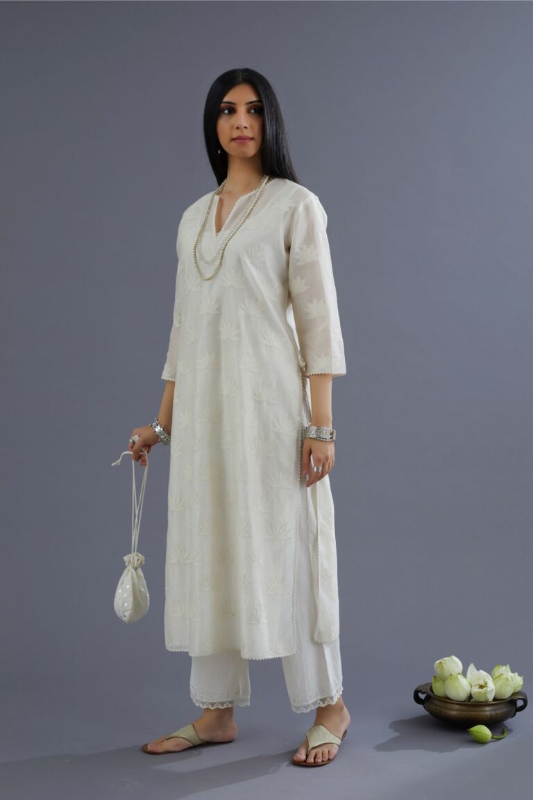 Off white chanderi kurta set with all-over applique flower embroidery and lace detailing at neck and side slits
