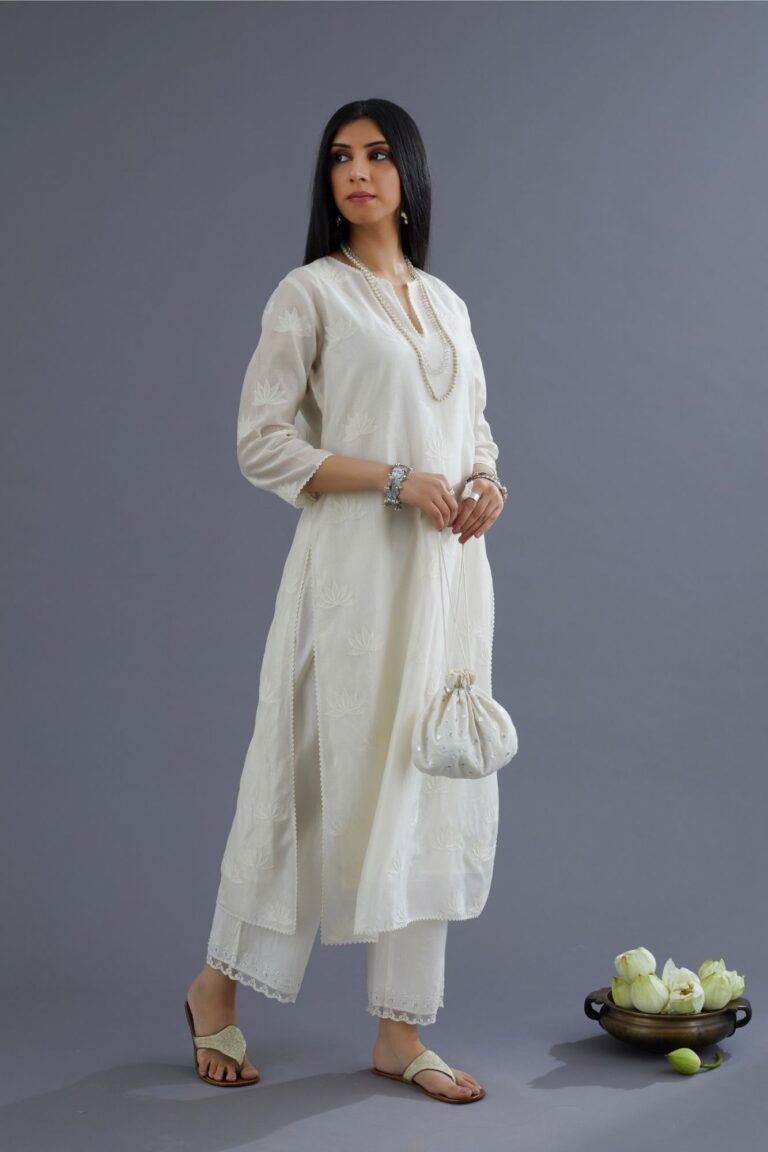 Off white silk chanderi kurta set with all-over applique lotus flower embroidery and lace detailing at neck and side slits