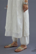 Off white silk chanderi kurta set with all-over applique lotus flower embroidery and lace detailing at neck and side slits