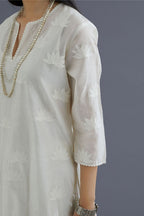 Off white silk chanderi kurta set with all-over applique lotus flower embroidery and lace detailing at neck and side slits