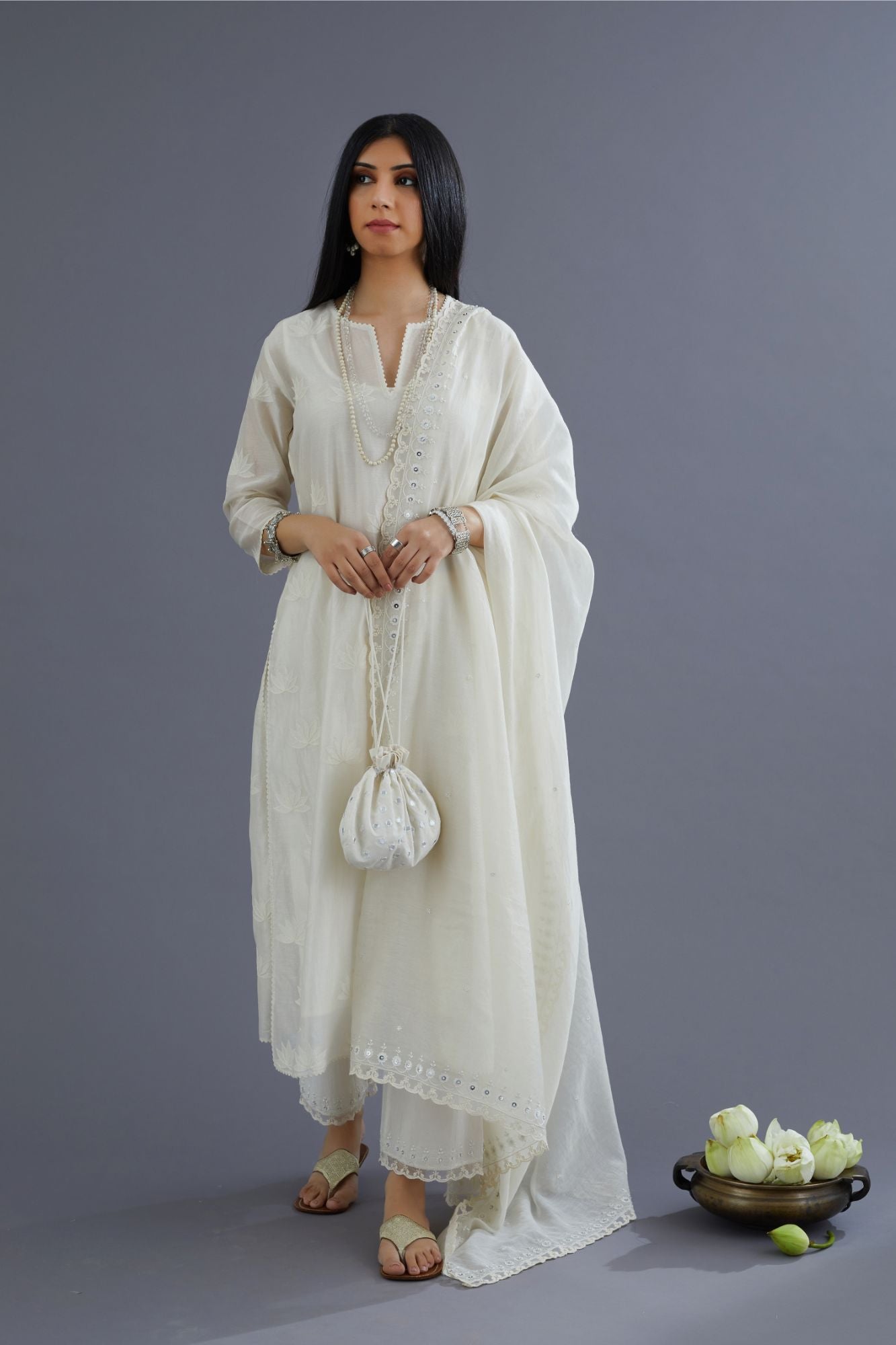 Off white silk chanderi kurta set with all-over applique lotus flower embroidery and lace detailing at neck and side slits