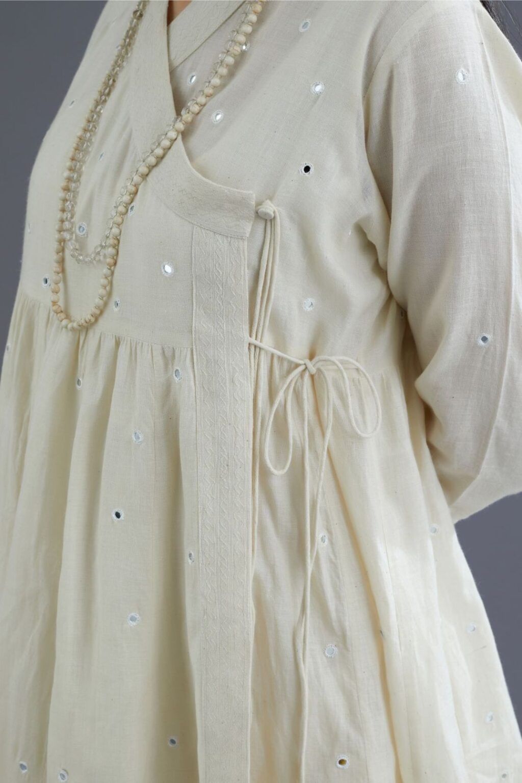 Off white Handspun Hand-Woven cotton short angrakha kurta set with  embroidered over-lapped neckline and mirror hand work
