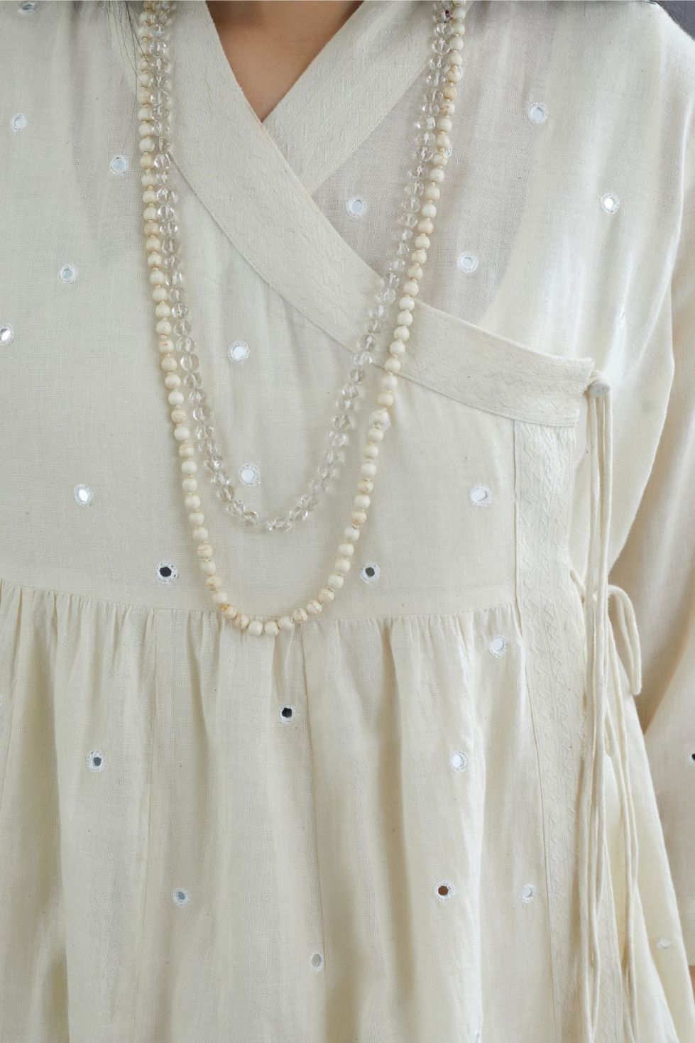 Off white Handspun Hand-Woven cotton short angrakha kurta set with  embroidered over-lapped neckline and mirror hand work