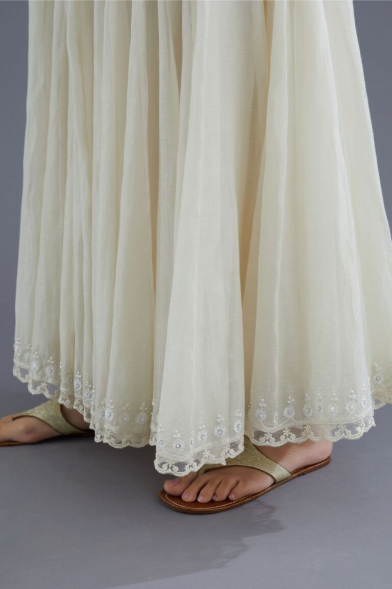 Off white cotton Chanderi multi panelled skirt with lace, embroidery and sequin hand work detailing at edges