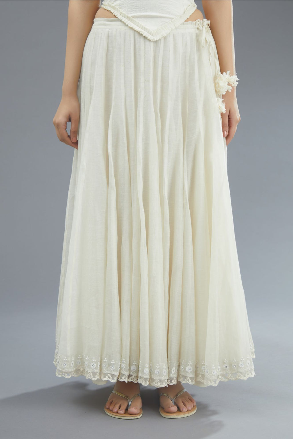 Off white cotton Chanderi multi paneled skirt with lace, embroidery and sequin hand work detailing at edges
