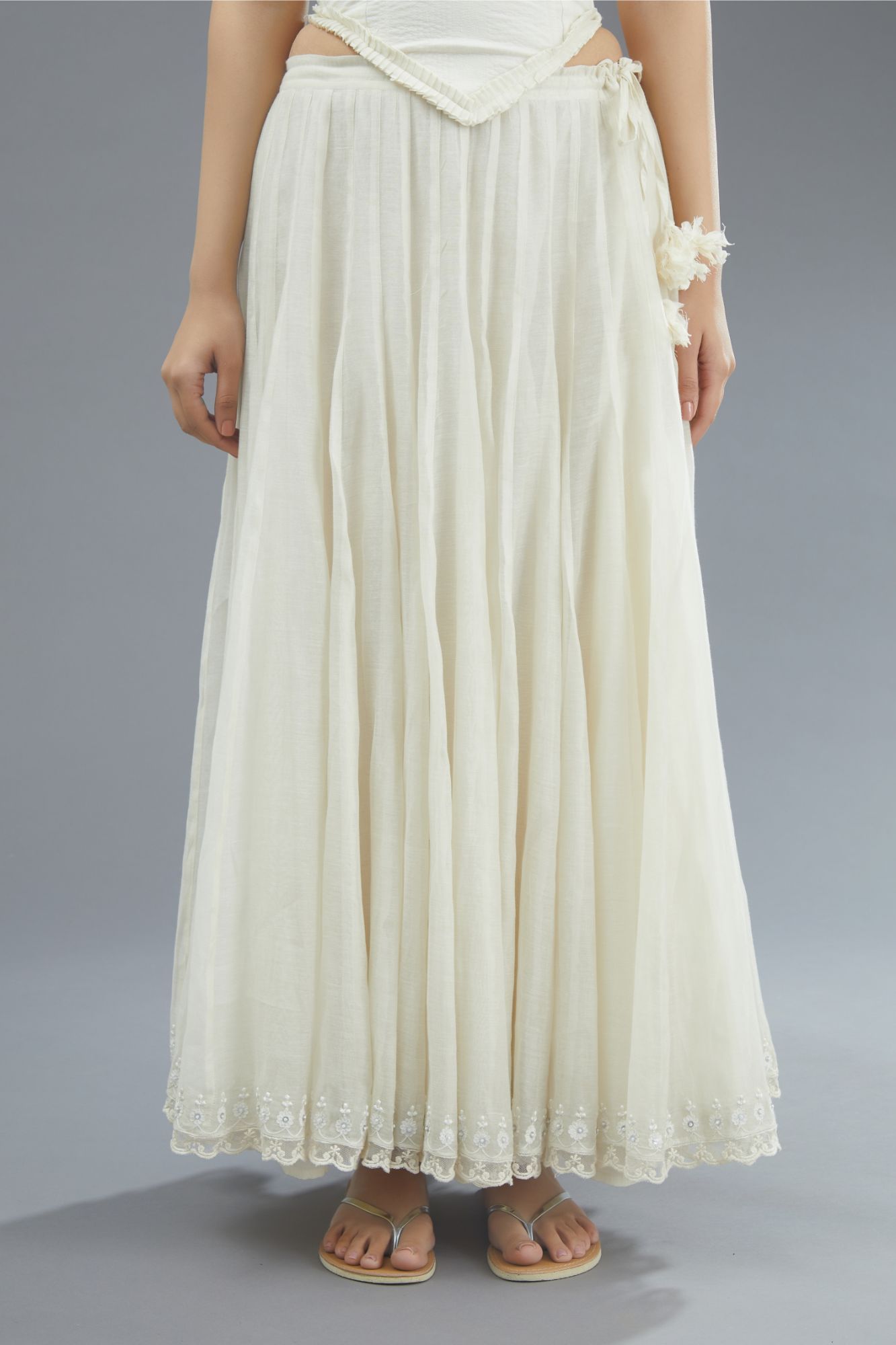 Off white cotton Chanderi multi paneled skirt with lace, embroidery and sequin hand work detailing at edges