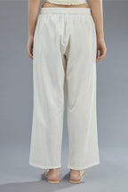 Off white straight pants detailed with pintucks at bottom.