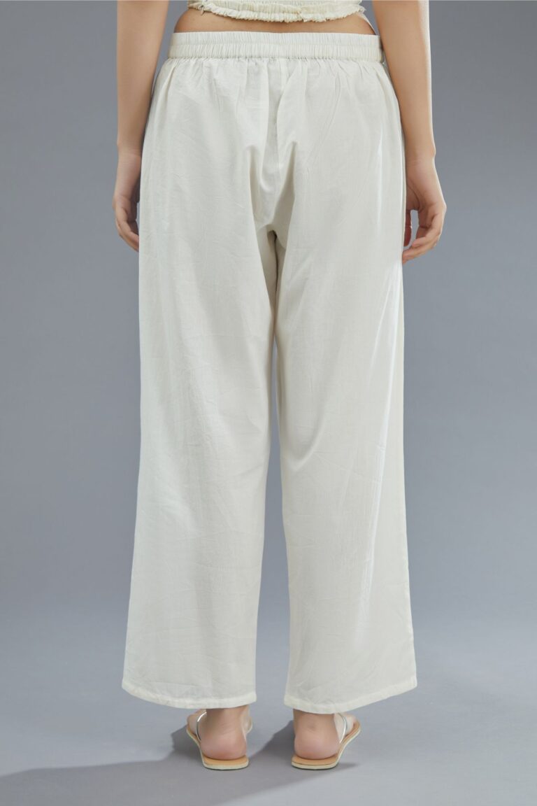 Off white straight pants detailed with pintucks at bottom.