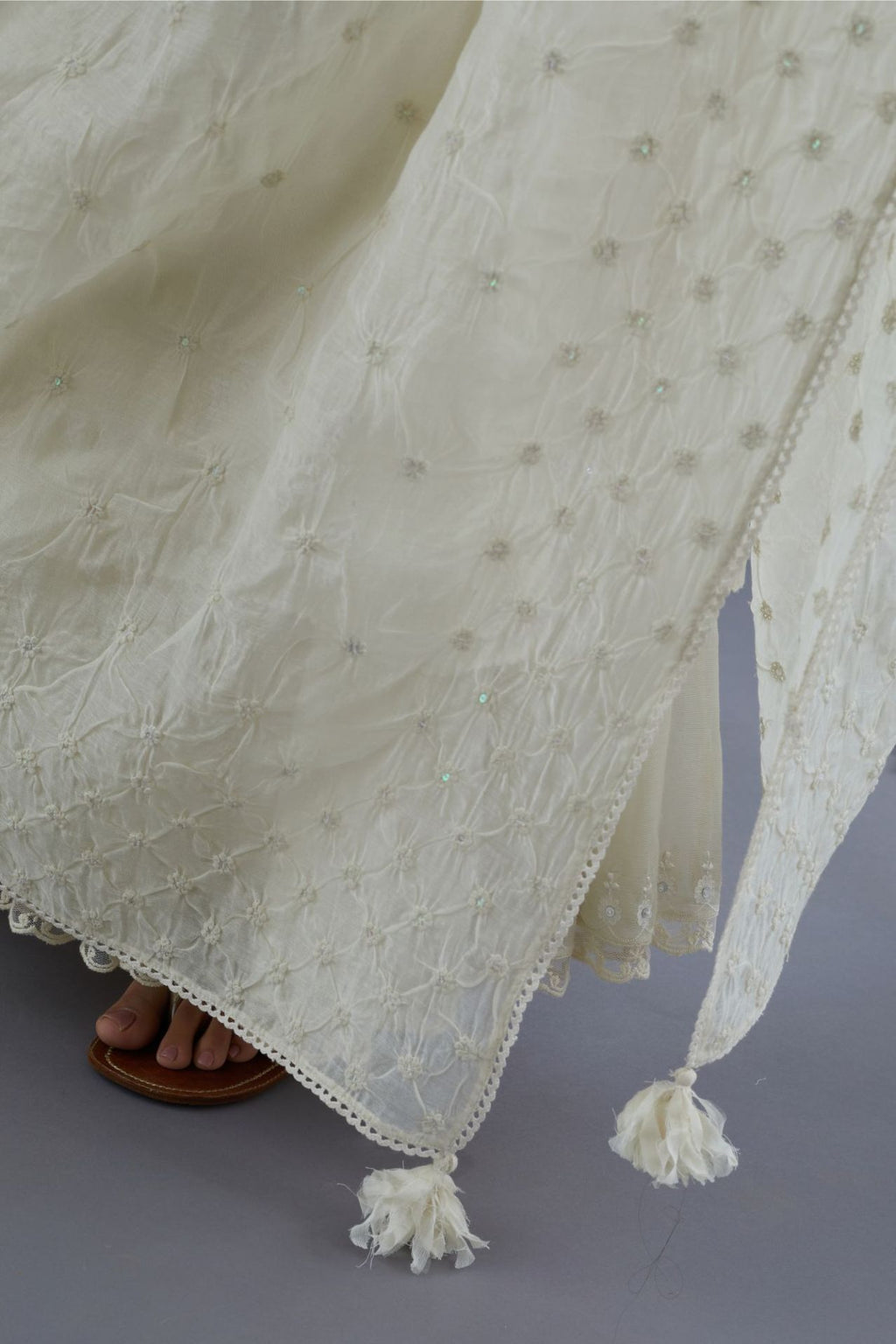 Cotton Chanderi dupatta with all over knotted thread embroidery and fabric tassels at all corners.