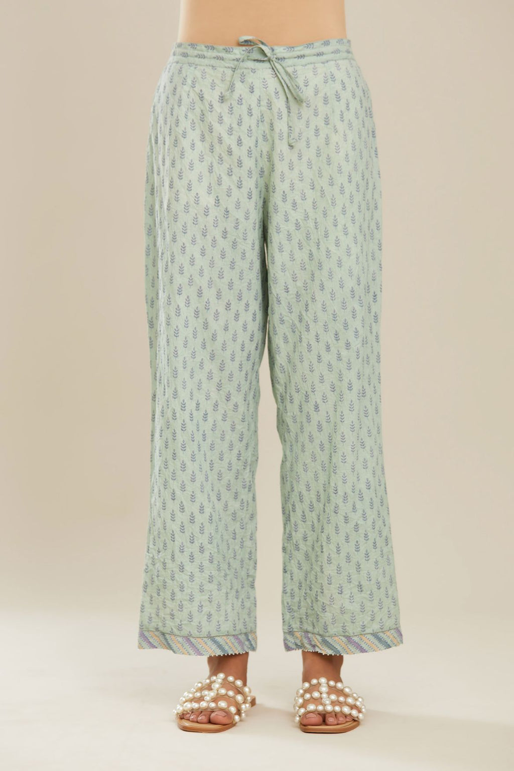 Blue hand block printed straight pants with striped fabric attached at bottom with faggoting and highlighted with hand attached beads. (PANTS)