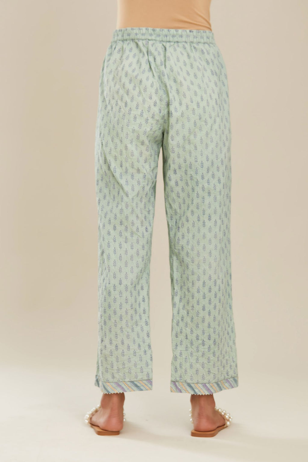 Blue hand block printed straight pants with striped fabric attached at bottom with faggoting and highlighted with hand attached beads. (PANTS)