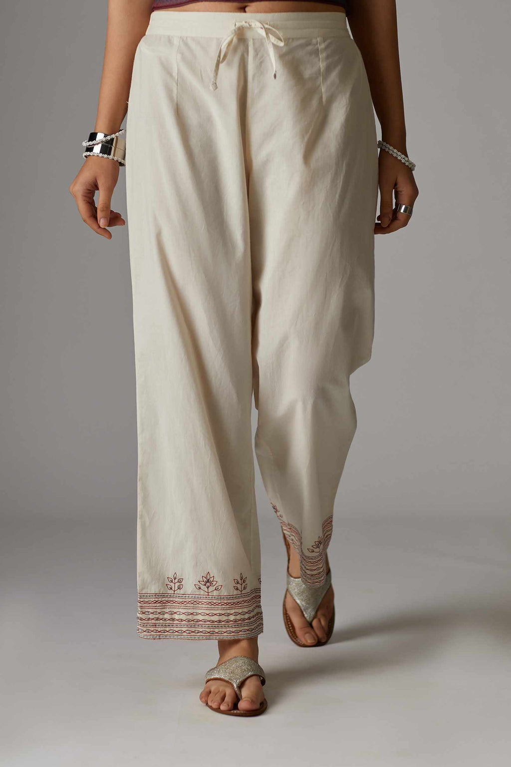 Off white straight pant with quilted embroidered hem