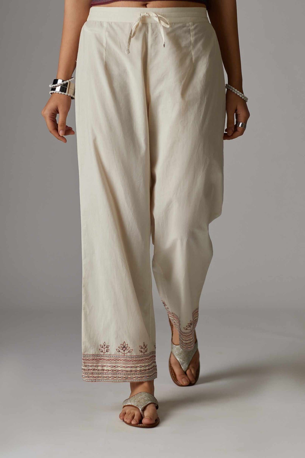 Off white straight pant with quilted embroidered hem