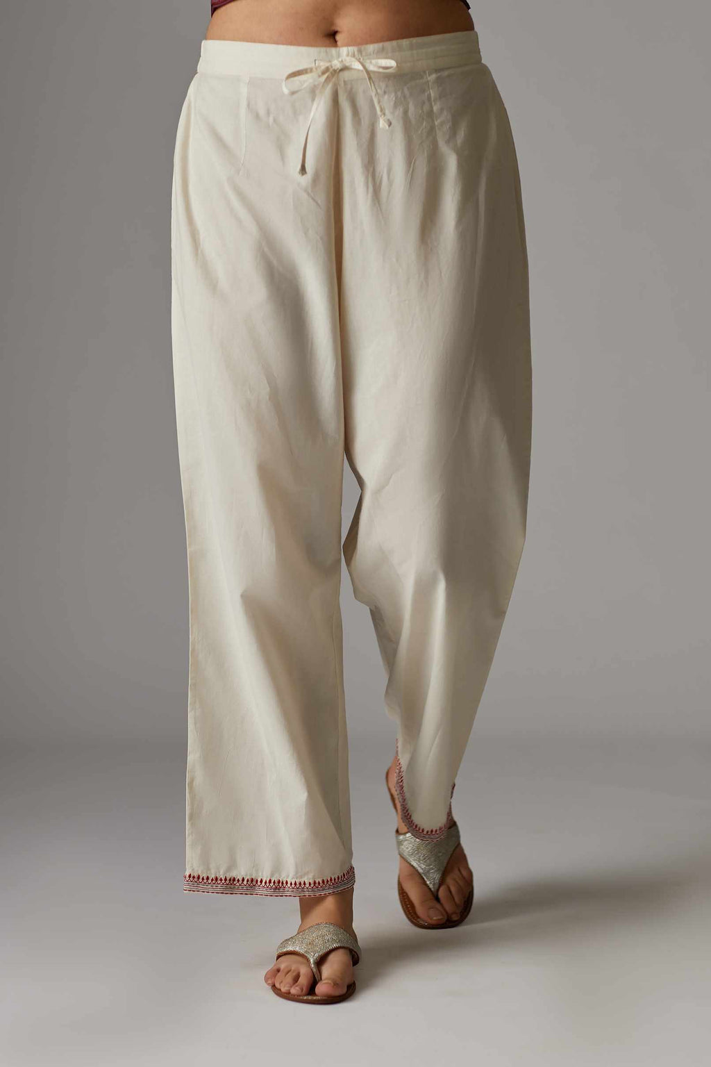Off white straight pant with contrast thread embroidered hem