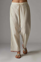 Off white straight pant with contrast thread embroidered hem