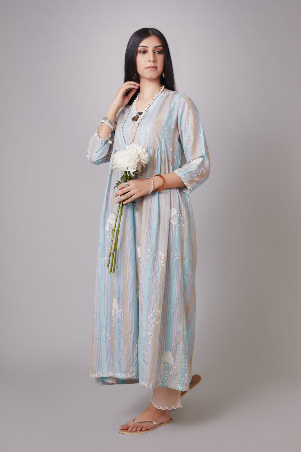 Multi striped hand-crushed silk kurta set with wavy empire waistline and gathers, highlighted with applique flower embroidery and mirror hand work.