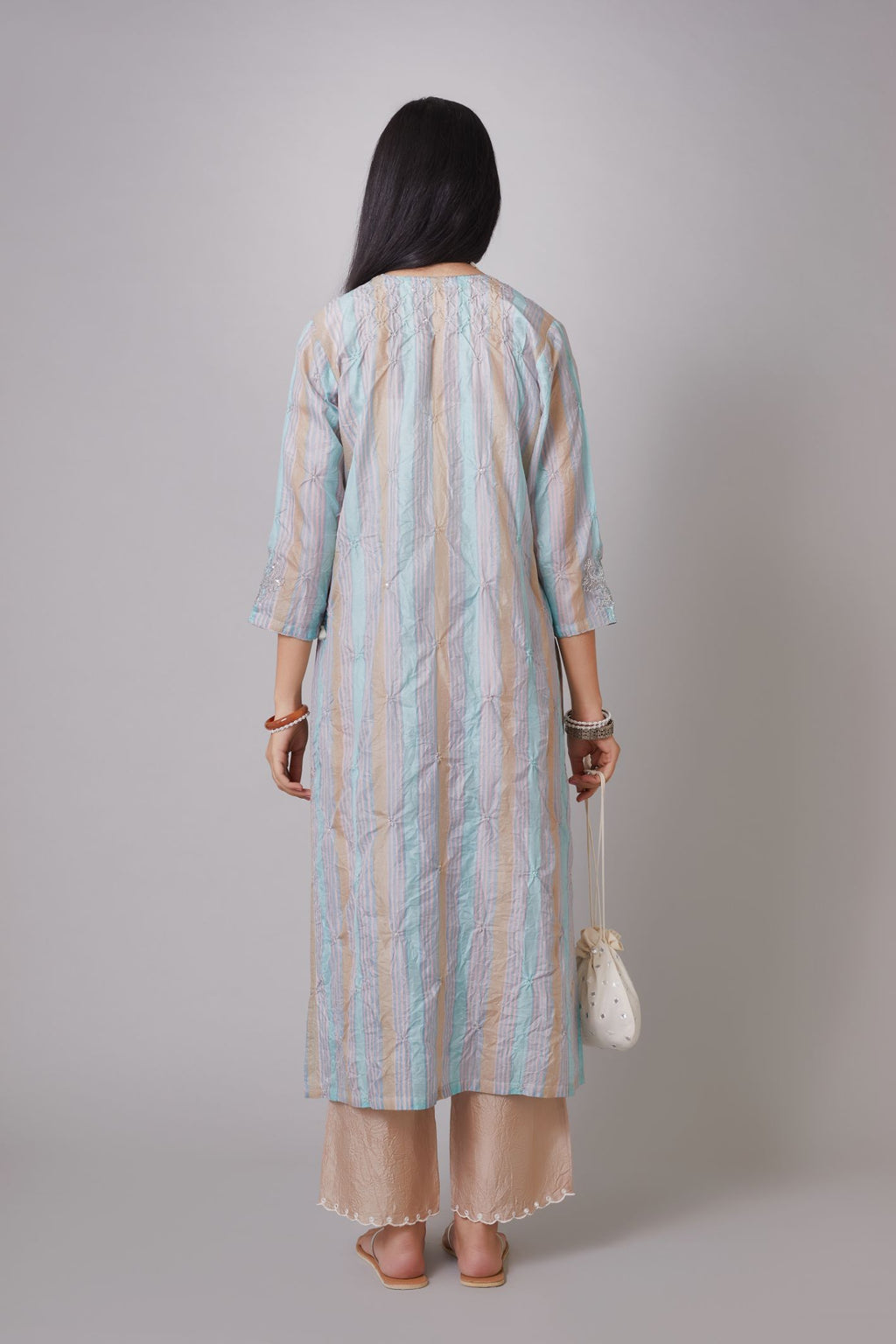 Multi striped hand block printed crushed silk kurta set embellished with sequins hand work.