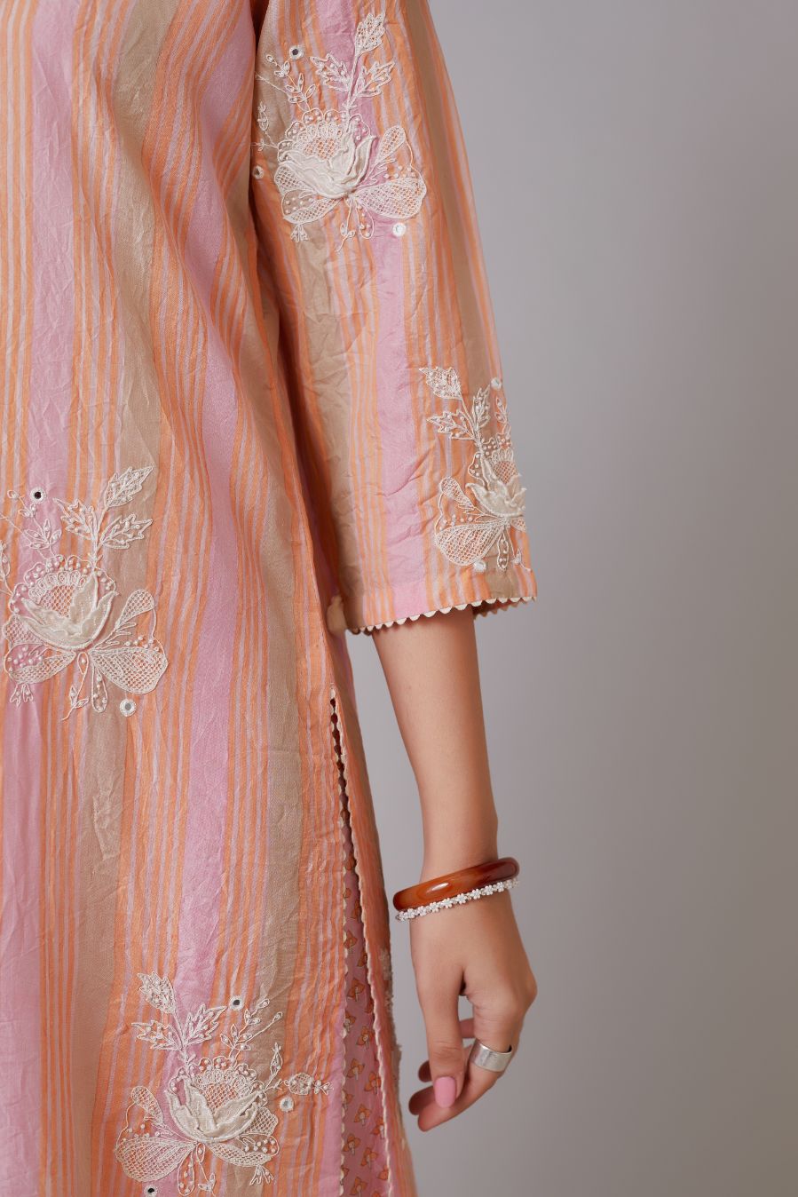 Multi striped hand crushed silk kurta set with raised flower embroidery, highlighted with mirror hand work.