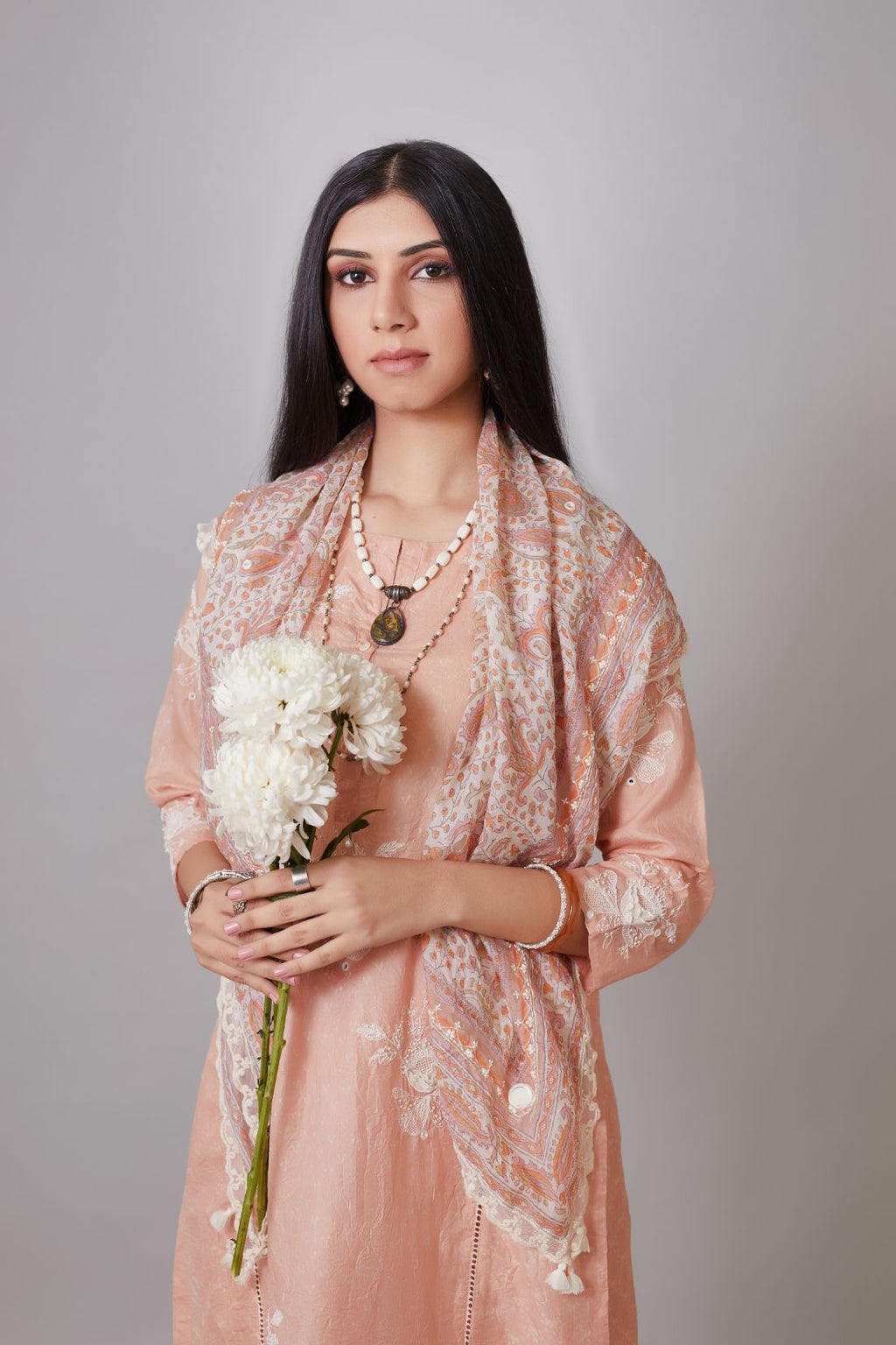 Hand crushed silk kurta set with raised flower embroidery, highlighted with mirror hand work and beads.