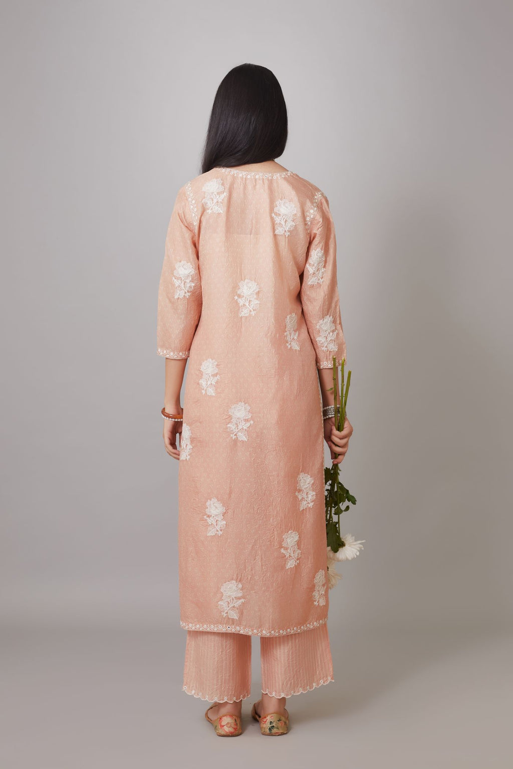 Peach hand block printed crushed silk kurta set with raised flower embroidery and mirror hand work.