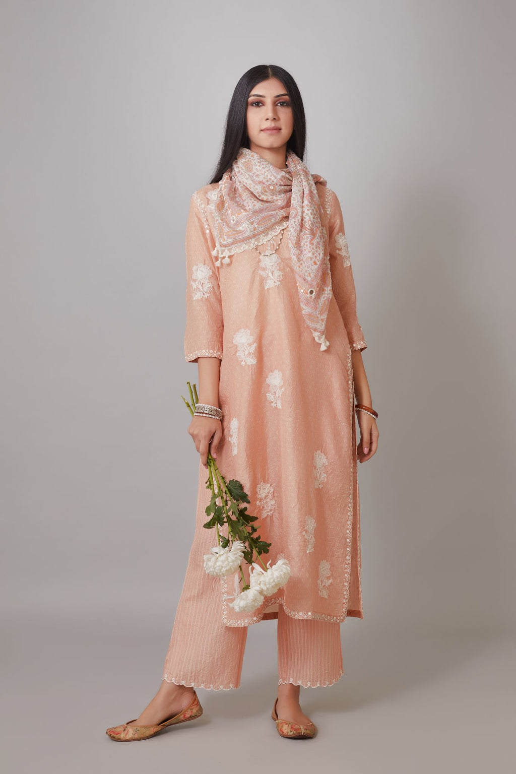 Peach hand block printed crushed silk kurta set with raised flower embroidery and mirror hand work.